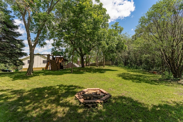 816 Bristol Ln NE, Rochester, MN 55906 - view of grassy yard featuring a fire pit and a playground