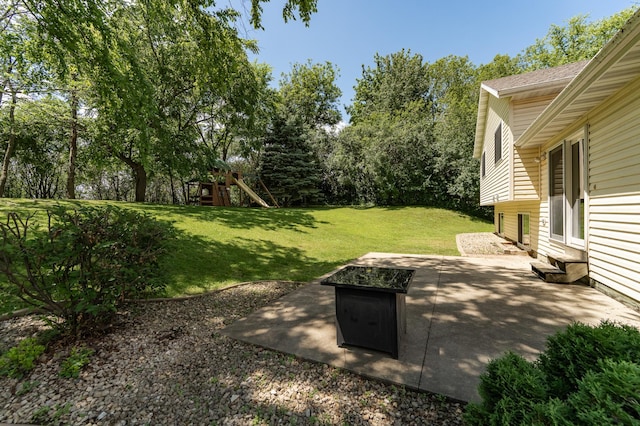 816 Bristol Ln NE, Rochester, MN 55906 - view of green lawn with entry steps, a patio area, an outdoor fire pit, and view of wooded area