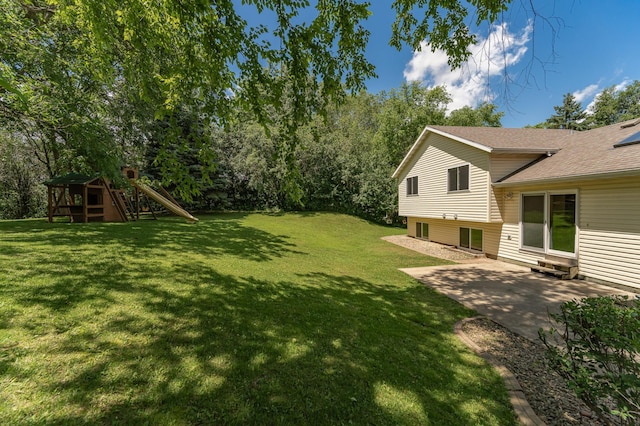 816 Bristol Ln NE, Rochester, MN 55906 - view of grassy yard with a patio area, a playground, and entry steps