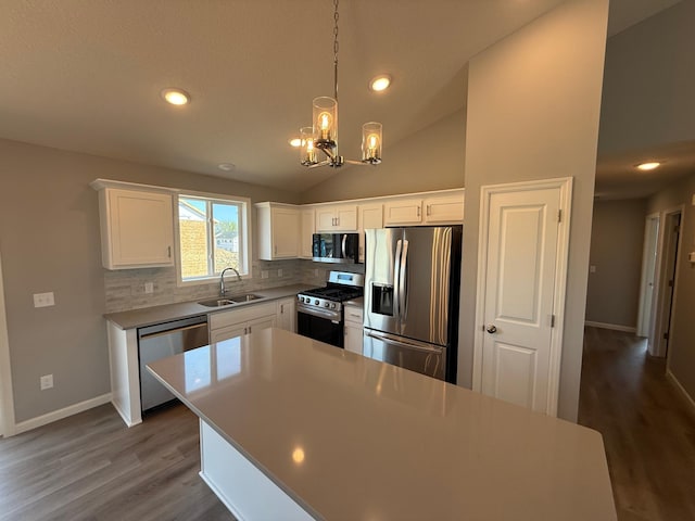 2883 Ivory Ave NE, Saint Michael, MN 55376 - kitchen featuring stainless steel appliances, decorative backsplash, dark wood finished floors, a chandelier, and white cabinets