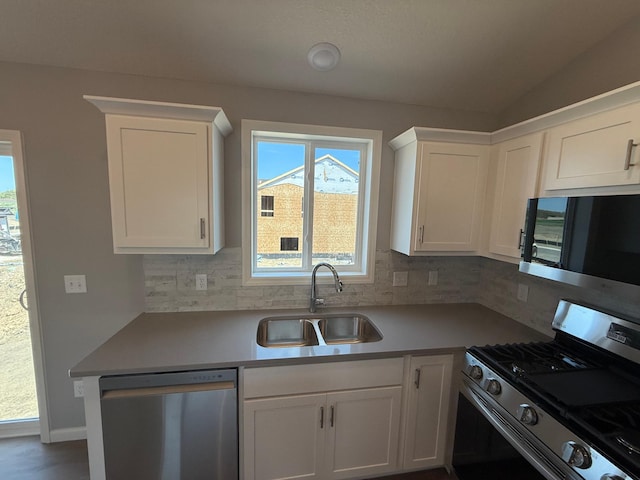 2883 Ivory Ave NE, Saint Michael, MN 55376 - kitchen with appliances with stainless steel finishes, decorative backsplash, white cabinets, light countertops, and lofted ceiling