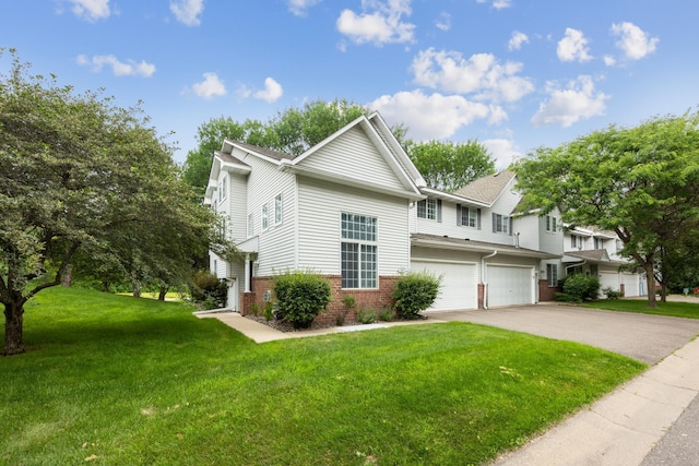 14000 Erwin Ct, Eden Prairie, MN 55344 - view of front facade with a garage, brick siding, driveway, and a front yard