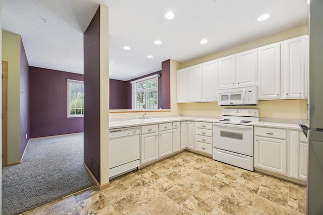 14000 Erwin Ct, Eden Prairie, MN 55344 - kitchen featuring white appliances, light colored carpet, recessed lighting, light countertops, and white cabinets