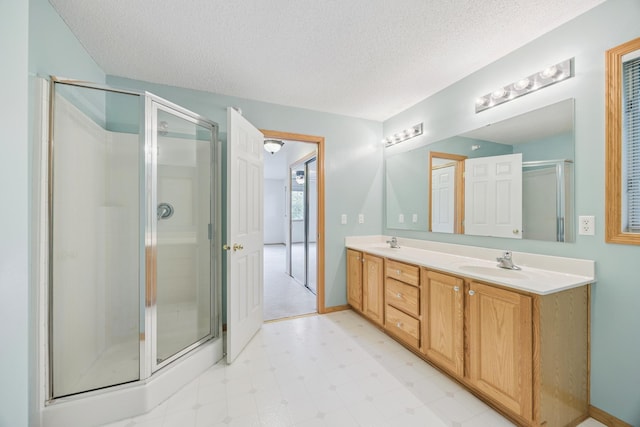 14000 Erwin Ct, Eden Prairie, MN 55344 - full bathroom with tile patterned floors, double vanity, a stall shower, and a textured ceiling