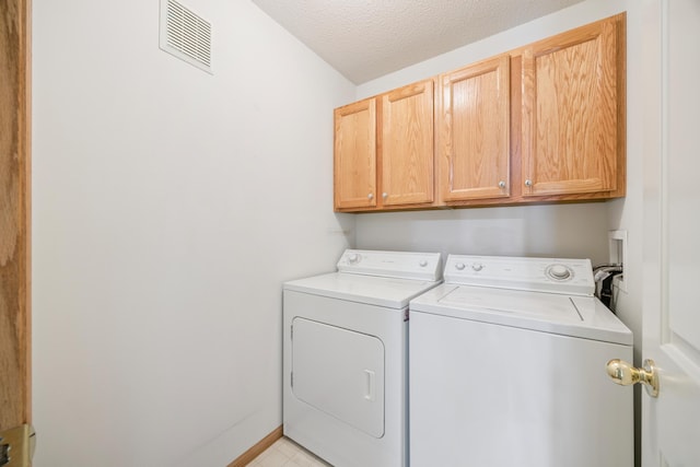 14000 Erwin Ct, Eden Prairie, MN 55344 - laundry area with cabinet space, washing machine and dryer, and a textured ceiling
