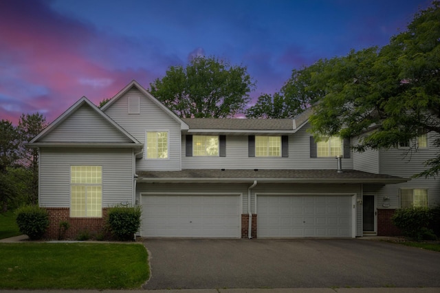 14000 Erwin Ct, Eden Prairie, MN 55344 - view of front of property with driveway, brick siding, and an attached garage