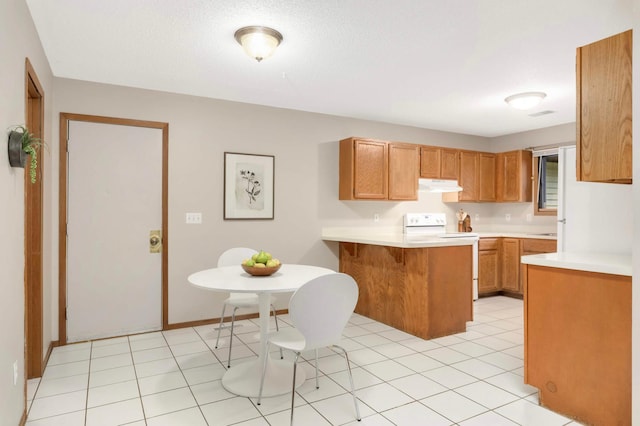 5960 Fernwood St, Shoreview, MN 55126 - kitchen featuring white electric stove, under cabinet range hood, a peninsula, light countertops, and a kitchen breakfast bar