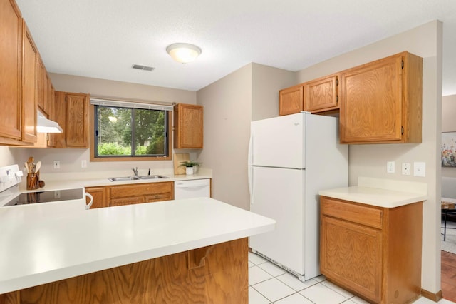 5960 Fernwood St, Shoreview, MN 55126 - kitchen with white appliances, under cabinet range hood, light countertops, a peninsula, and light tile patterned flooring