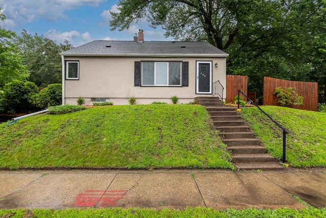 188 Cleveland Ave S, Saint Paul, MN 55105 - view of front of house with stucco siding, a chimney, and a shingled roof