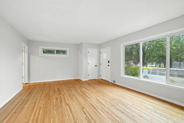 188 Cleveland Ave S, Saint Paul, MN 55105 - unfurnished living room with light wood-style floors and baseboards