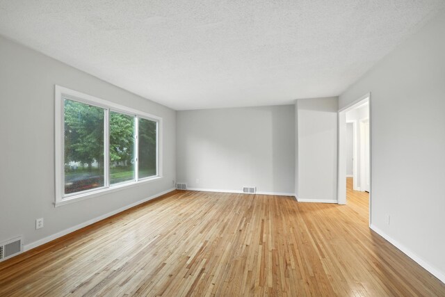 188 Cleveland Ave S, Saint Paul, MN 55105 - spare room with wood-type flooring and a textured ceiling