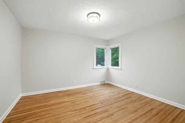 188 Cleveland Ave S, Saint Paul, MN 55105 - empty room featuring light wood-type flooring and a textured ceiling