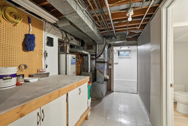 188 Cleveland Ave S, Saint Paul, MN 55105 - below grade area featuring gas water heater, heating unit, and light tile patterned flooring