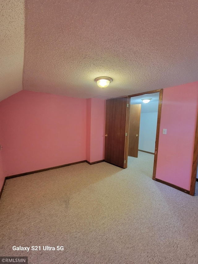 150 Gillis Ave S, Browerville, MN 56438 - spare room with light colored carpet, a textured ceiling, and vaulted ceiling