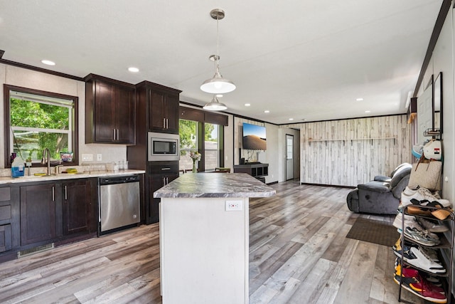 217 Mayfair Rd, Vadnais Heights, MN 55127 - kitchen featuring stainless steel appliances, open floor plan, light wood-style flooring, dark brown cabinetry, and ornamental molding