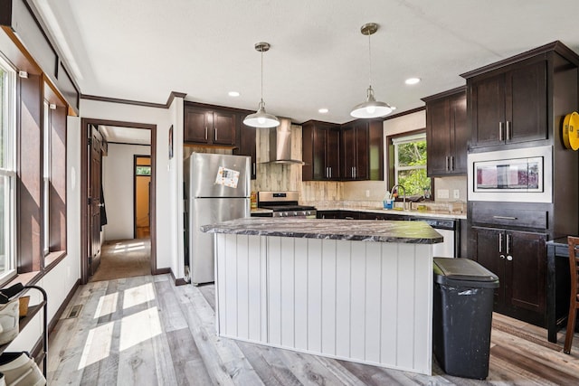 217 Mayfair Rd, Vadnais Heights, MN 55127 - kitchen with appliances with stainless steel finishes, dark brown cabinets, wall chimney exhaust hood, light wood-type flooring, and recessed lighting
