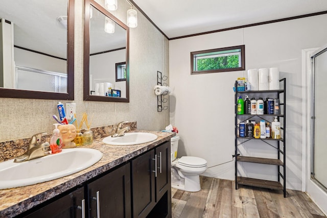 217 Mayfair Rd, Vadnais Heights, MN 55127 - bathroom featuring wood finished floors, an enclosed shower, double vanity, and ornamental molding