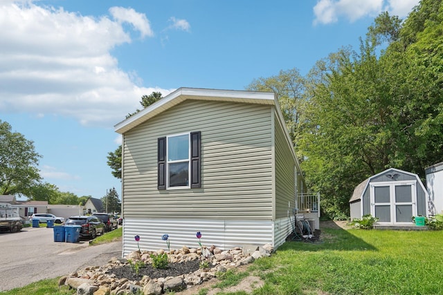 217 Mayfair Rd, Vadnais Heights, MN 55127 - view of side of home featuring a storage shed and a lawn