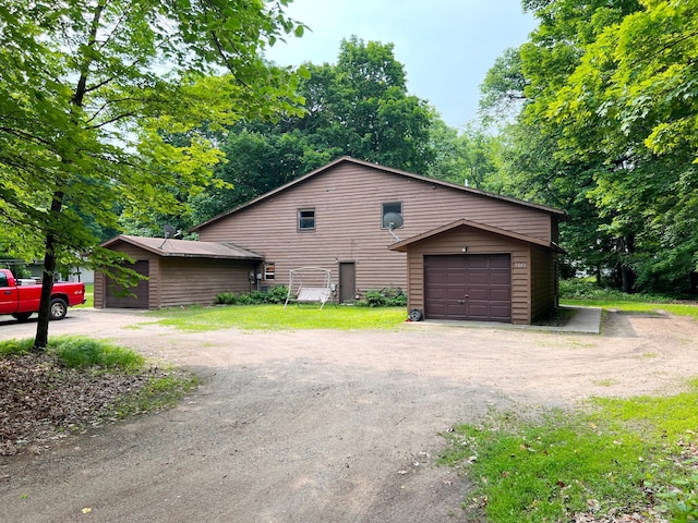 5019/5021 Ojibwa Rd, Brainerd, MN 56401 - view of home's exterior featuring an outdoor structure and dirt driveway