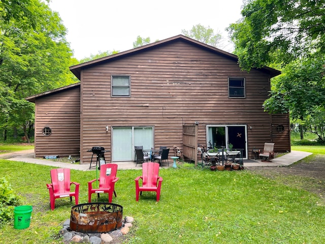 5019/5021 Ojibwa Rd, Brainerd, MN 56401 - back of property featuring an outdoor fire pit, a lawn, and a patio area