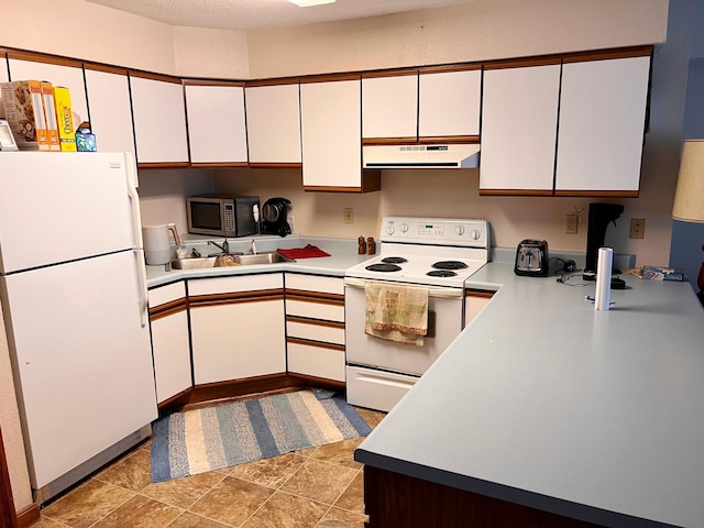 5019/5021 Ojibwa Rd, Brainerd, MN 56401 - kitchen featuring white appliances, under cabinet range hood, white cabinets, and light countertops