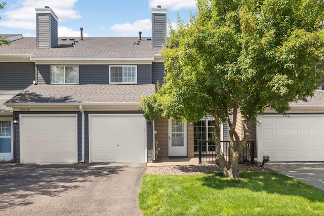 1830 Donegal Dr Unit 11, Woodbury, MN 55125 - view of front facade with a chimney, asphalt driveway, roof with shingles, and a front lawn