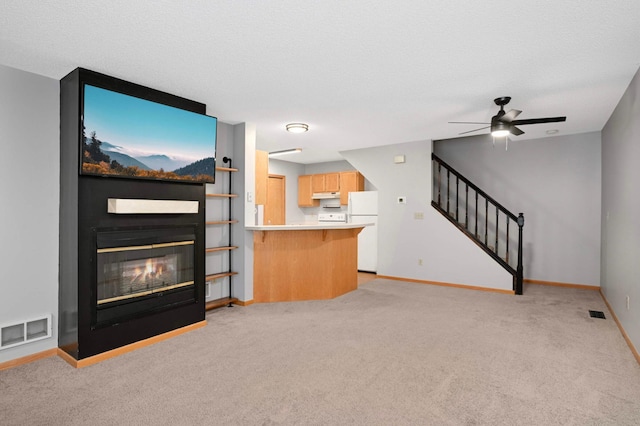 1830 Donegal Dr Unit 11, Woodbury, MN 55125 - unfurnished living room with light colored carpet, a fireplace, ceiling fan, and stairs