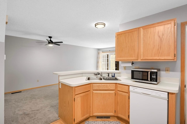1830 Donegal Dr Unit 11, Woodbury, MN 55125 - kitchen with white dishwasher, stainless steel microwave, a peninsula, a ceiling fan, and light countertops