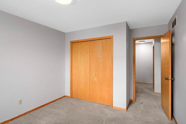 1830 Donegal Dr Unit 11, Woodbury, MN 55125 - unfurnished bedroom with light carpet, a closet, and a textured ceiling