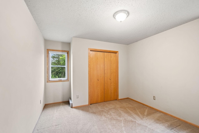 20170 Oxboro Ln N, Scandia, MN 55047 - unfurnished bedroom featuring light carpet, a closet, and a textured ceiling