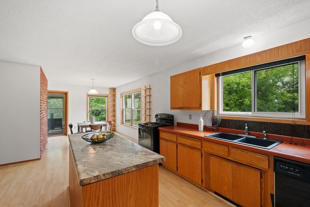 20170 Oxboro Ln N, Scandia, MN 55047 - kitchen featuring black appliances, light wood-type flooring, healthy amount of natural light, a center island, and a textured ceiling