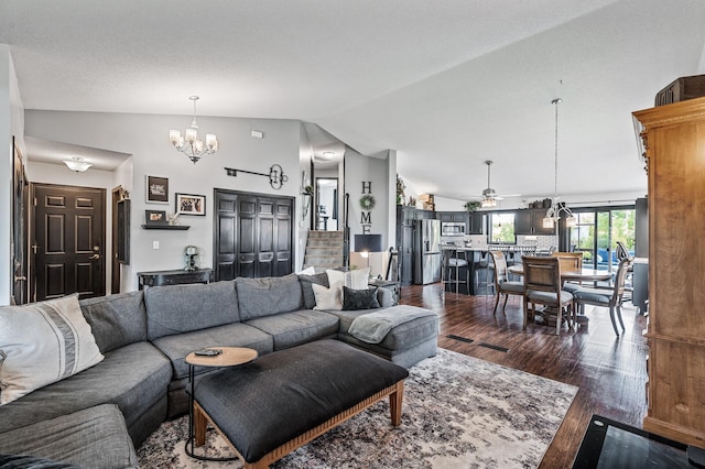11847 Meadow Curv, Lindstrom, MN 55045 - living room featuring dark wood finished floors, vaulted ceiling, a chandelier, and a ceiling fan