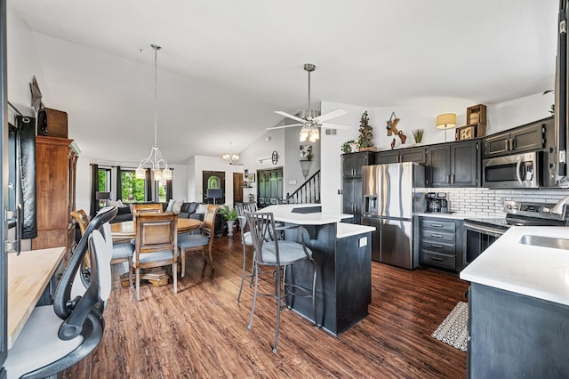 11847 Meadow Curv, Lindstrom, MN 55045 - kitchen featuring stainless steel appliances, dark wood-style flooring, light countertops, a center island, and lofted ceiling