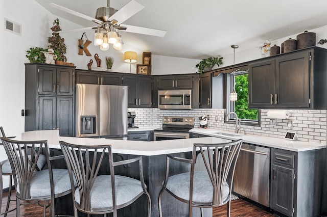 11847 Meadow Curv, Lindstrom, MN 55045 - kitchen featuring stainless steel appliances, vaulted ceiling, backsplash, a ceiling fan, and light countertops