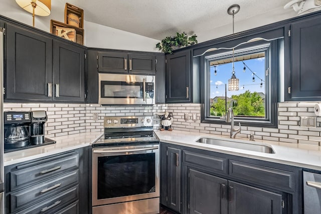 11847 Meadow Curv, Lindstrom, MN 55045 - kitchen with stainless steel appliances, backsplash, light countertops, a textured ceiling, and decorative light fixtures
