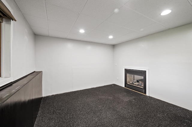 11847 Meadow Curv, Lindstrom, MN 55045 - unfurnished living room featuring a glass covered fireplace, carpet, recessed lighting, and a drop ceiling