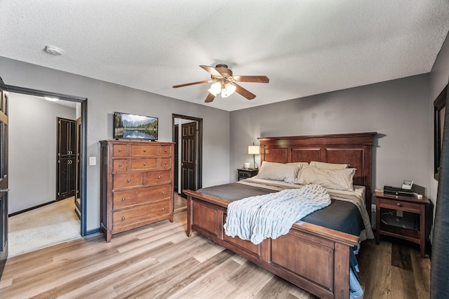 11847 Meadow Curv, Lindstrom, MN 55045 - bedroom with light wood-style floors, a textured ceiling, and ceiling fan