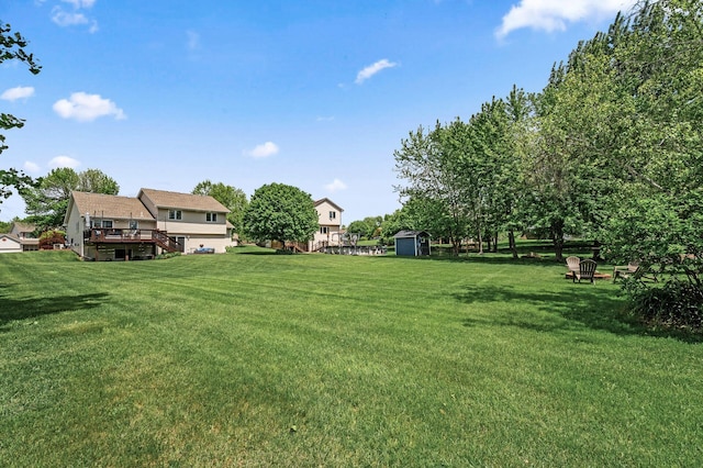 11847 Meadow Curv, Lindstrom, MN 55045 - view of green lawn featuring a storage shed and a wooden deck