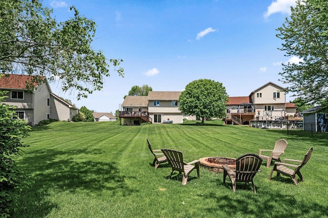 11847 Meadow Curv, Lindstrom, MN 55045 - view of green lawn with a fire pit, a wooden deck, and stairway