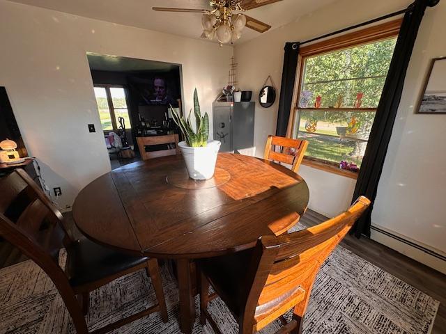 3507 Salo Rd, Waasa Twp, MN 55732 - dining room featuring a ceiling fan, baseboard heating, and wood finished floors