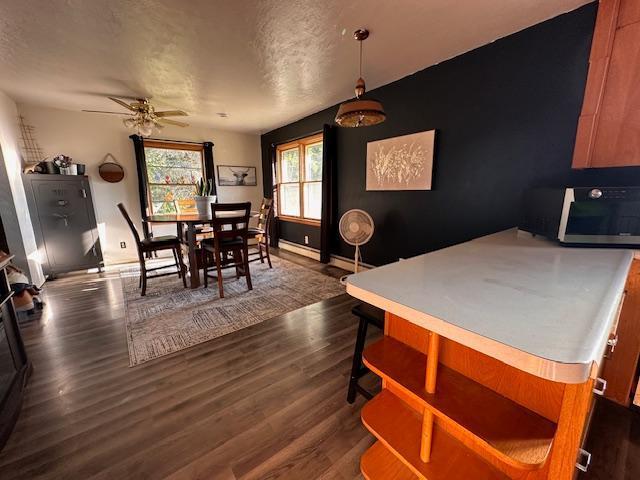 3507 Salo Rd, Waasa Twp, MN 55732 - dining room with a ceiling fan, dark wood-type flooring, and a textured ceiling