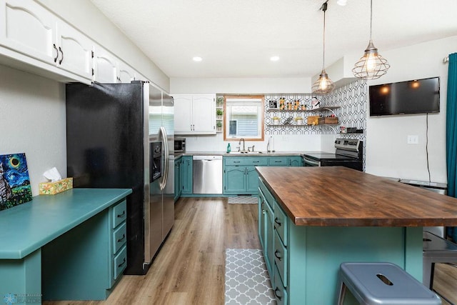 105 5th Ave W, West Fargo, ND 58078 - kitchen featuring stainless steel appliances, butcher block countertops, white cabinets, open shelves, and light wood-style flooring