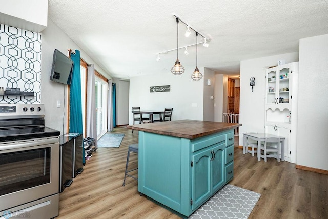 105 5th Ave W, West Fargo, ND 58078 - kitchen with stainless steel range with electric stovetop, blue cabinets, wooden counters, a textured ceiling, and light wood-style floors