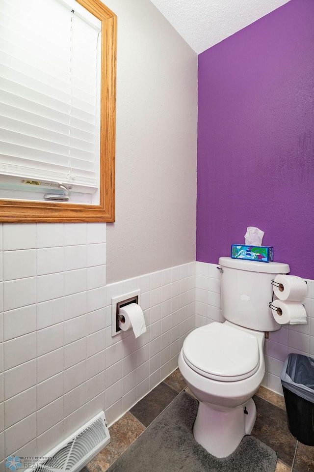 105 5th Ave W, West Fargo, ND 58078 - half bath featuring tile walls and a wainscoted wall