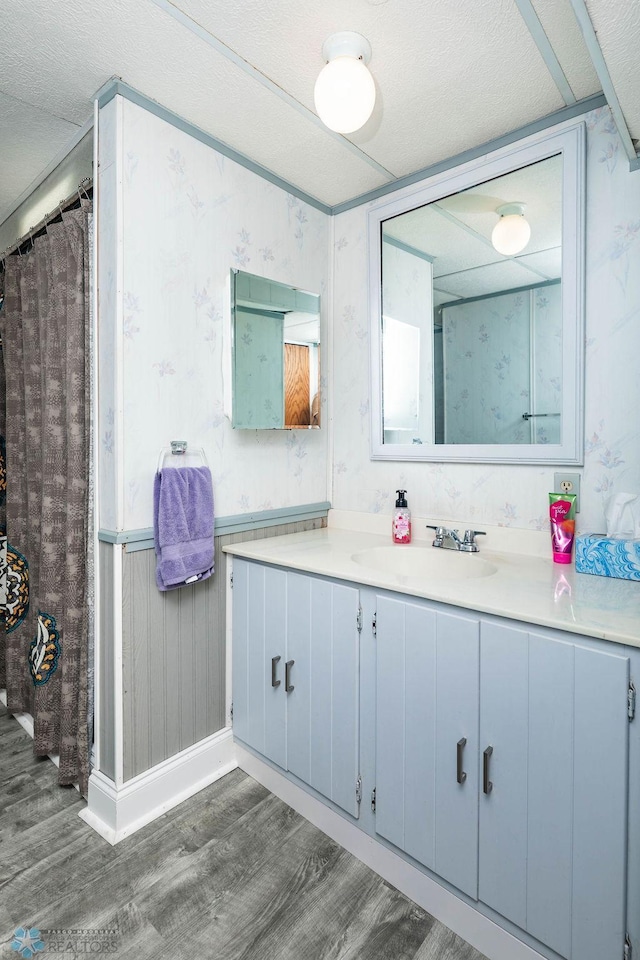105 5th Ave W, West Fargo, ND 58078 - full bathroom featuring wood finished floors, vanity, and wallpapered walls