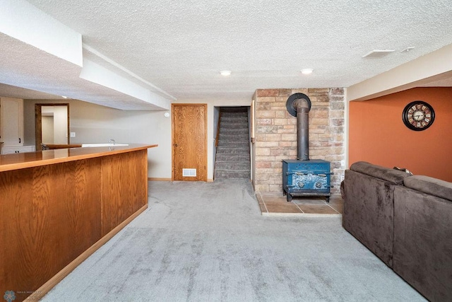 105 5th Ave W, West Fargo, ND 58078 - indoor bar featuring a wood stove, carpet floors, and a textured ceiling