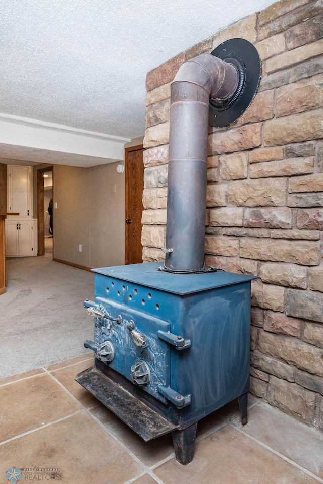 105 5th Ave W, West Fargo, ND 58078 - detailed view of a wood stove, a textured ceiling, and carpet floors