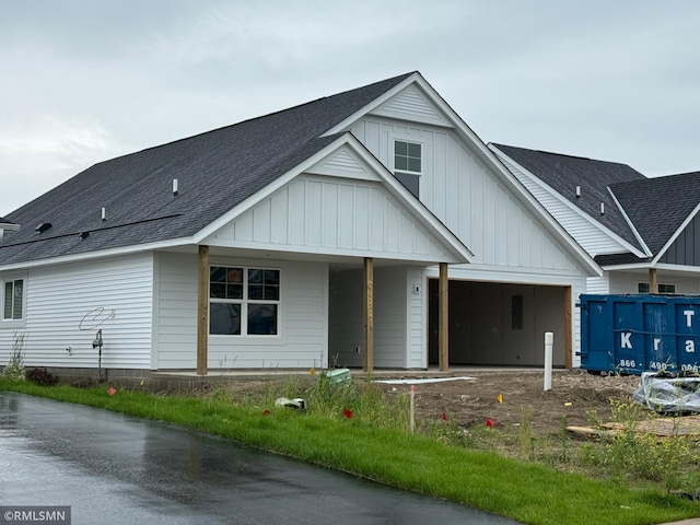 2488 Jacamar Ave NE, Saint Michael, MN 55376 - view of front of property featuring a shingled roof, a garage, board and batten siding, and driveway