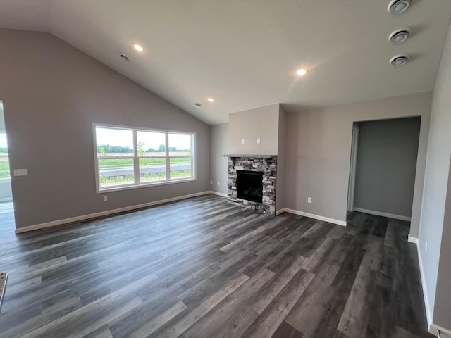 2488 Jacamar Ave NE, Saint Michael, MN 55376 - unfurnished living room with vaulted ceiling, dark wood-style flooring, recessed lighting, and a stone fireplace