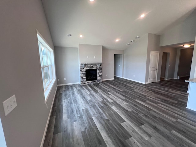 2488 Jacamar Ave NE, Saint Michael, MN 55376 - unfurnished living room featuring vaulted ceiling, dark wood-style flooring, recessed lighting, and a fireplace